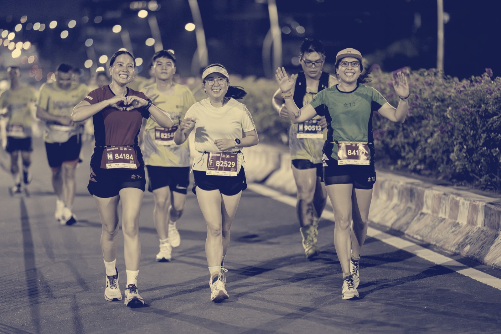 A joyful group of runners at a night race