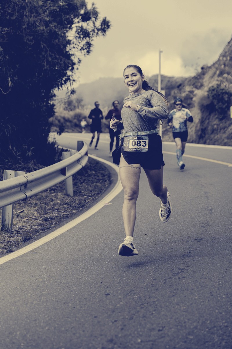 Joyful runner on a mountain road race